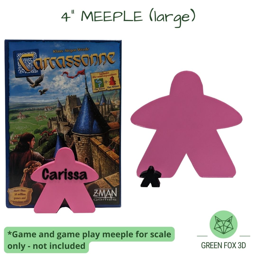 A comparison of a personalized, 4 inch meeple against game token and board game box.